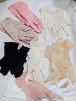 All nine pairs of vintage gloves laid out to show colours, styles and condition