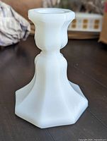 Side view of milk glass candlestick holder showing overall shape and condition