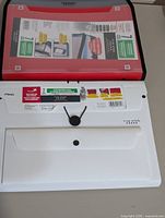 Front view of white folder and packaged red/black folder