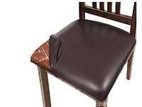Dark brown faux leather seat cover partially fitted on a wooden chair seat