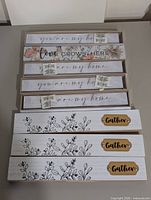 All seven wooden decor signs stacked: four slim signs on top, three wider 'Gather' signs below