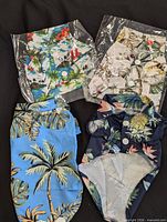 Four assorted tropical print small dog shirts, two unopened in packaging