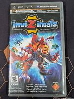 Front view of Invizimals PSP game case showing artwork, branding and rating