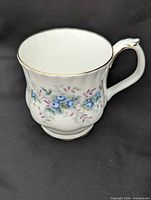 Blue floral Royal Albert mug showing pattern, shape and gold trim