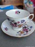 Royal Vale bone china floral teacup and saucer, gold rimmed, no visible damage