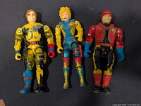 Front view of three 1986 LJN Bionic Six figures showing paint wear