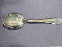 Full view of commemorative teaspoon, bowl to handle