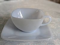 Milk glass teacup on square saucer
