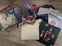 Stacks of assorted vinyl LPs showing several identifiable album covers
