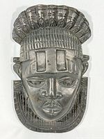 Front view of carved wood wall mask