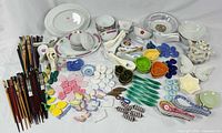 Full lot overview showing plates, bowls, spoons, chopsticks, rests and teapot