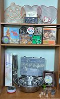 Full shelf view showing bowls, cutters, racks, tip case