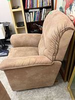 Left side view of beige microfiber recliner showing overall shape and upholstery