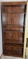 Full frontal view of bookcase showing overall structure and brass corner accents