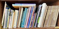 Shelf view of assorted gardening books showing spines and variety