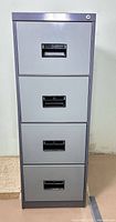 Front view of closed gray four-drawer metal filing cabinet