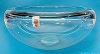 Side profile of clear glass bowl showing thick walls and label