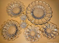 Seven nested glass bowls/plates displayed