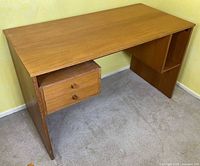 Teak desk front angled view showing top, side panel, drawer stack and cubby