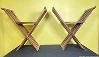 Two identical solid wood slat folding chairs side by side showing overall form