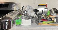 Countertop view showing majority of mixed kitchenware items