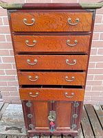 Front view of assembled tallboy showing drawers and cabinet