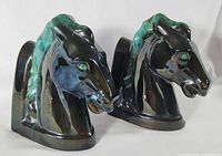 Front angled view of both ceramic horse head bookends