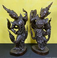 Both carved wood Kinnari statues full view