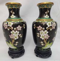 Front view showing cherry blossom design on both vases with stands