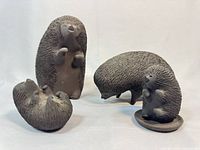 All four black ceramic hedgehog figurines in various poses