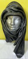 Front view showing silver face and black leather drape