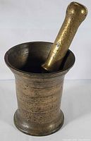 mortar with pestle inserted, frontal angle