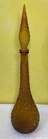 Full view of amber hobnail genie bottle with stopper