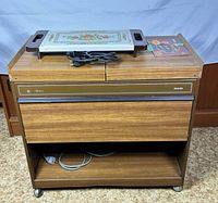 Closed cart with Rowenta warming tray and power cords on top