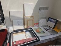 Group shot of all canvases, panels and frame on table