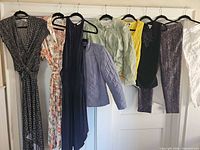 All eight garments hanging on door for overview