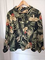Front view of floral tropical jacket on hanger