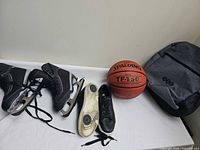 Group view of all four items: dance shoes, basketball, ice skates, backpack