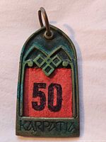 Front view showing number 50, patina and split ring
