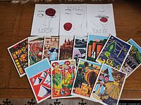 Group shot of all postcards and prints spread on table