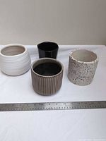 All four planters beside ruler for scale