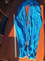 Full view of crinkled silk dupatta beside yardstick for scale