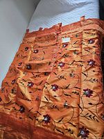 Full view of both curtain panels laid flat showing color, embroidery and tab tops