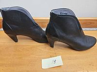 Side profile of both boots showing heel height and leather condition