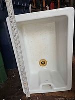 Full view of sink with ruler showing depth and length