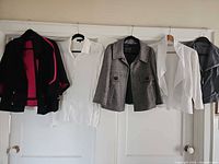 All five garments on hangers