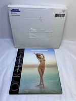 Front cover of book with model image and carton behind
