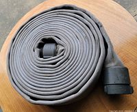 Rolled grey fire hose showing overall appearance