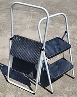 Front view of both folding step stools showing frames and steps