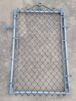 Front view of entire gate showing frame, mesh, latch, hinges, scroll top.